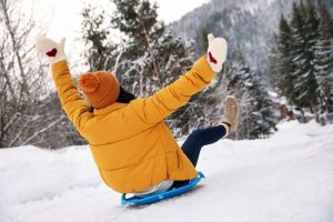 Woman sledding outdoors