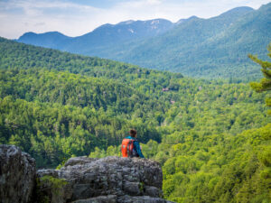 Boy sits at the edge of the cliff