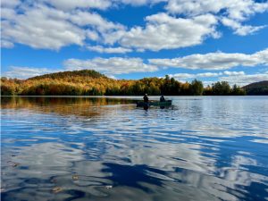 canoe with passengers rowing through calm waters